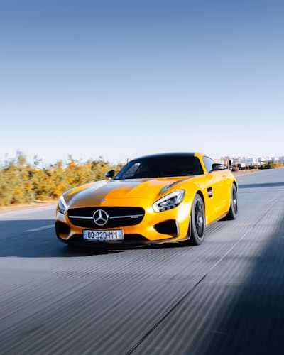 Yellow sports car photographed on a road, used as an illustrative standalone photo